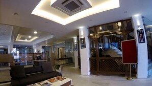 A modern living area with a sofa, coffee table, and a glass partition. - Marcopolo (Kathmandu)