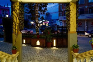 A gated entrance with a paved pathway leading to a building. - Marcopolo (Kathmandu)