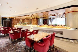 A restaurant with red chairs, a buffet counter, and a patterned carpet. - Shaanxi Iron and Steel Building (Xi'an)