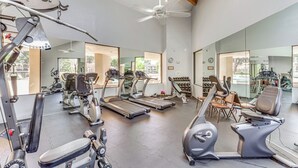 Ein Fitnessstudio mit Laufbändern, Crosstrainern und Kurzhanteln.