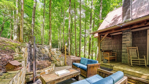 A rustic wooden cabin with a stone wall and a wooden deck. - Cozy Nature Escape! Roaring Gap Cabin w/ Patio (Roaring Gap)