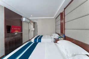 A hotel room with two beds, a wooden headboard, a nightstand, and a red sign on the wall. - Hongwuxing International Hotel (Ruijin)