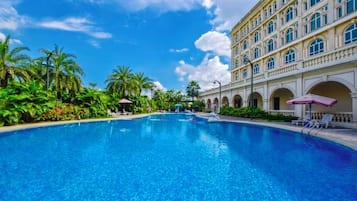 A large swimming pool with a building in the background.