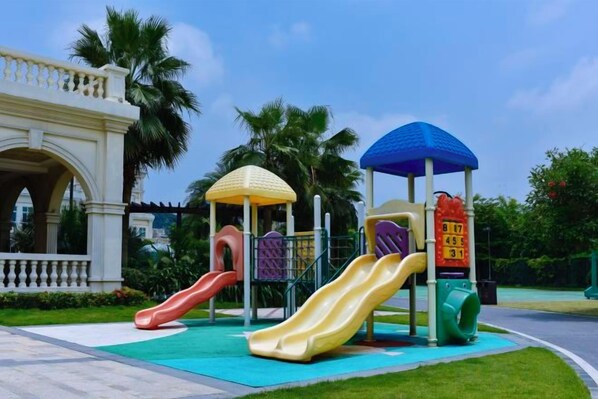 A playground with multiple slides and a covered play structure. - Xiqiao Mountain Qiaoyue Resort Hotel (Foshan)
