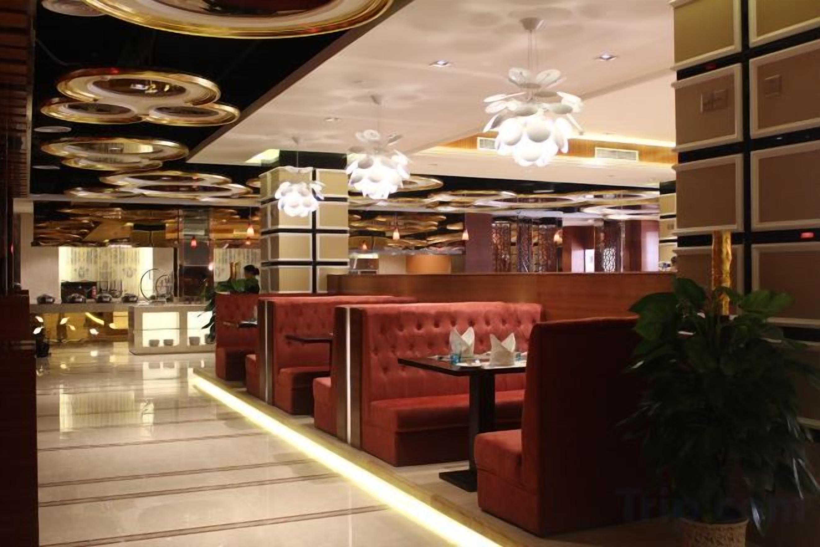 A modern interior with seating areas, a bar, and decorative lighting.