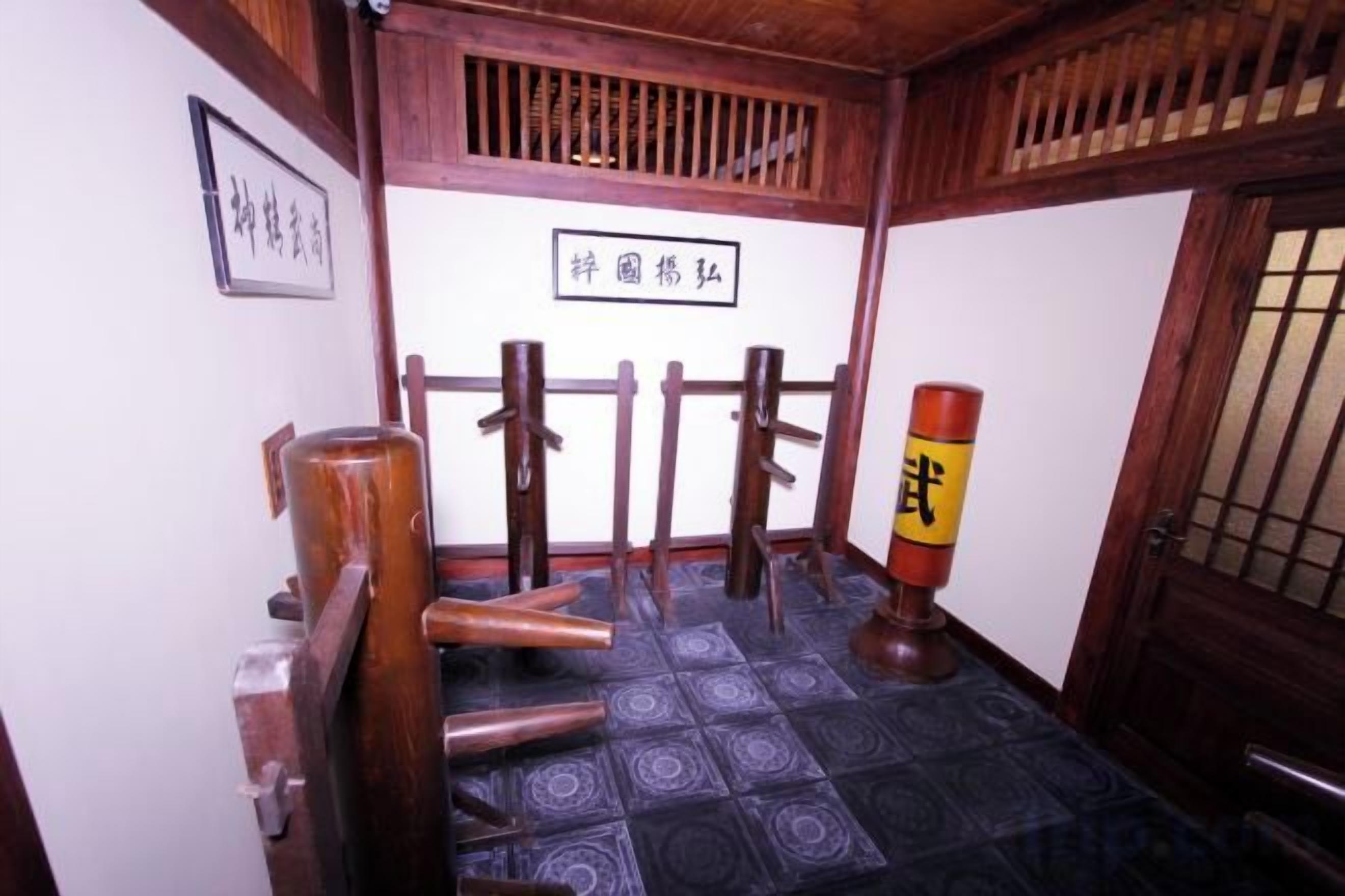 A traditional Japanese room with tatami flooring, a shoji screen, and a wooden door.