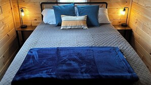 A cozy bedroom with a bed, pillows, and bedside lamps. - Bear Lake | Hot Tub, Kayaks, Firepit, Lake & Beach (Lake)