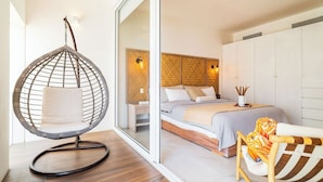 A bedroom with a bed, a hanging chair, and a view of the outside. - Opulence in Cabo is Waiting, Amplify Your Vacation. (Cabo San Lucas)