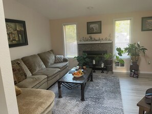 Cozy living space with a comfortable sofa, coffee table, and fireplace.