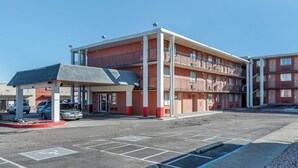 A multi-story motel with a covered parking area and a visible entrance. - Pueblo Inn (Pueblo)