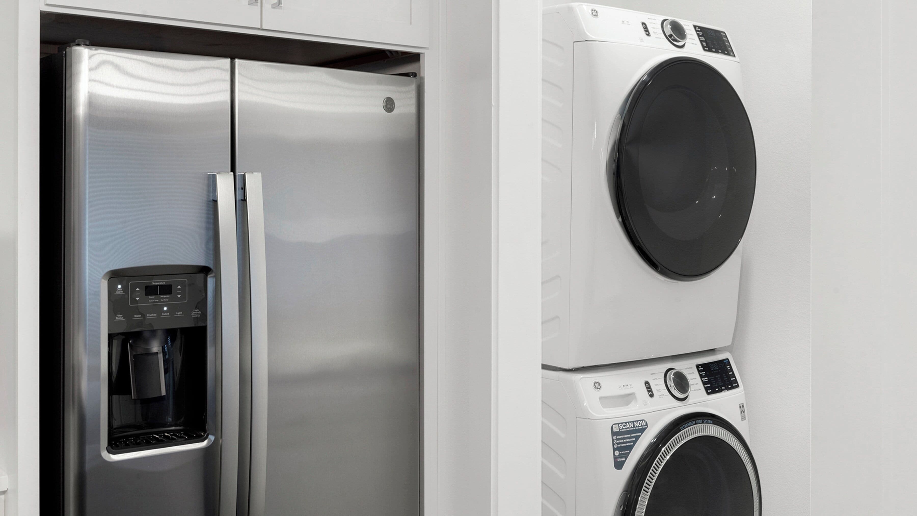 A stainless steel refrigerator with a built-in water dispenser and a front freezer compartment.