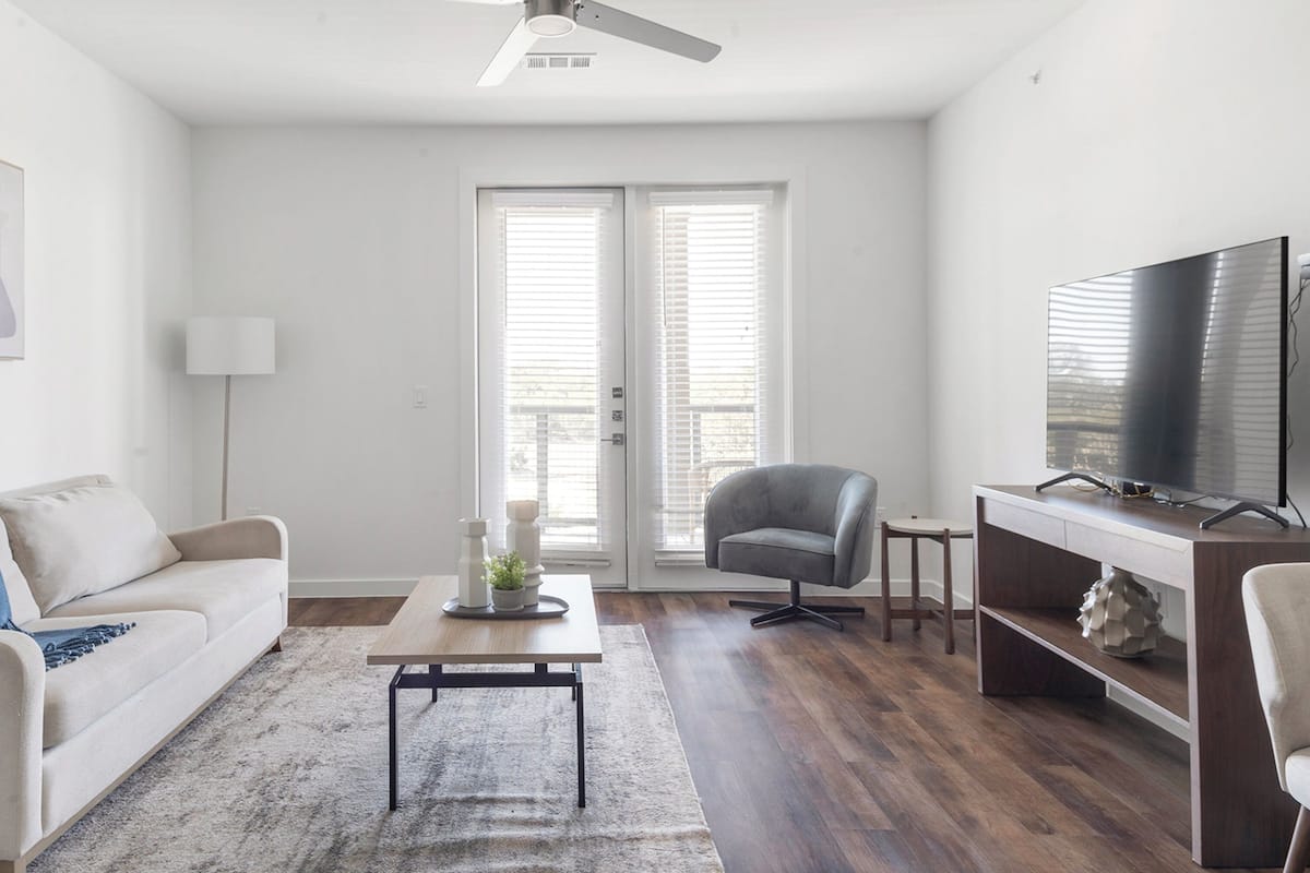 A modern living room with a sofa, coffee table, and TV.