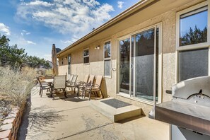 A patio with outdoor furniture, a grill, and a view of the surrounding landscape. - Vacation Home With Breathtaking Views, Ample Parking and Pool Table (Cañon City)