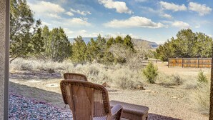 A patio with wicker furniture, a gravel path, and a view of trees and mountains. - Vacation Home With Breathtaking Views, Ample Parking and Pool Table (Cañon City)