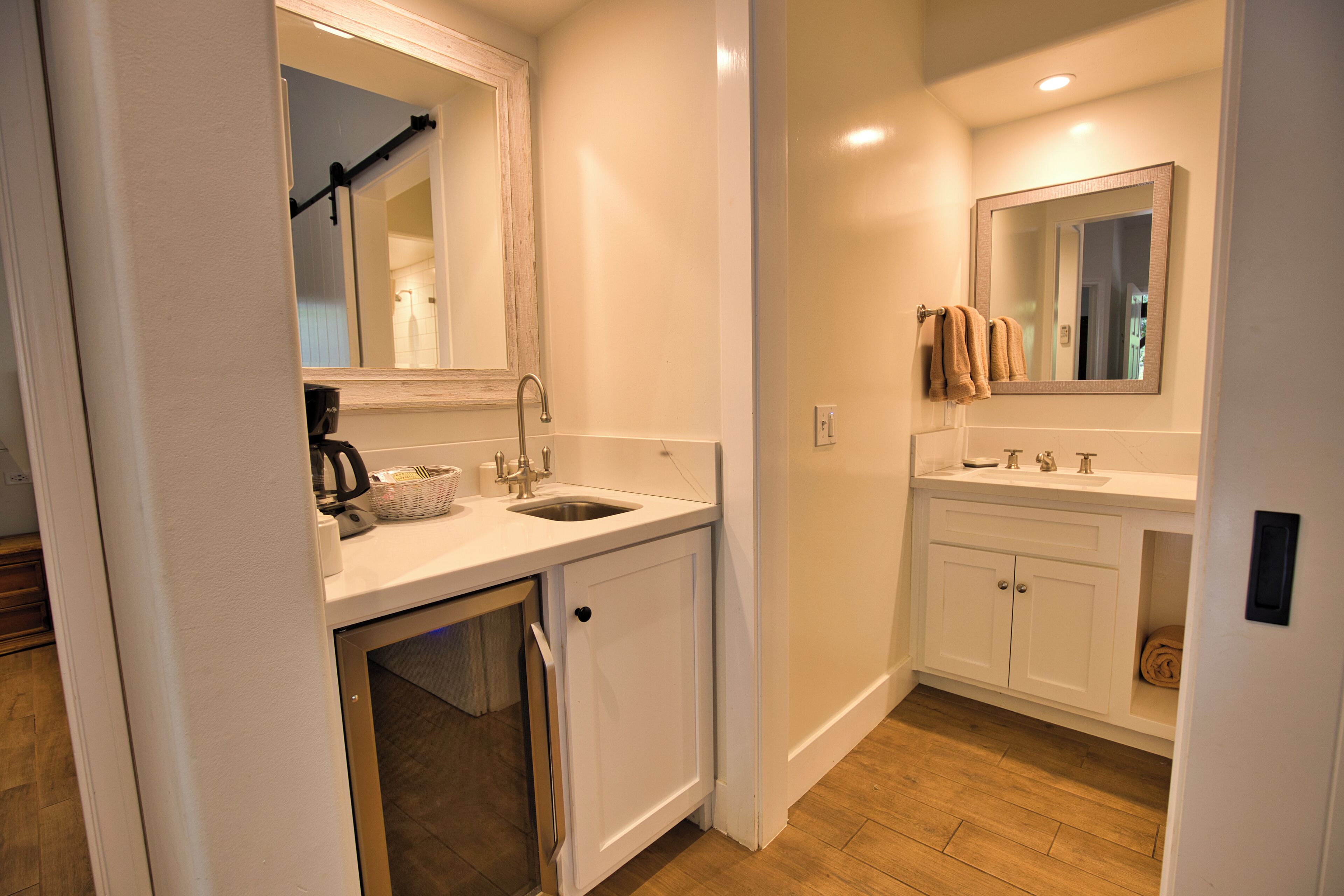 A compact bathroom with a sink, mirror, and cabinet.