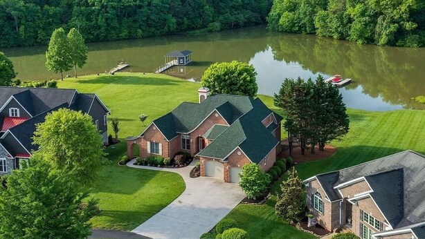 A residential area with houses, a dock, and a lake. - Tranquil Tellico Lakefront Retreat -- Kayaks! Private Dock! (Loudon)