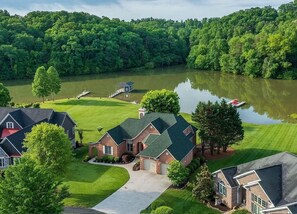 A residential area with houses, a dock, and a lake.