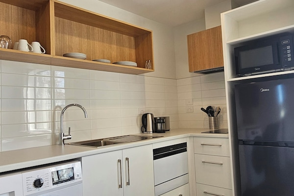 Premium 1 Bedroom Apartment | Private kitchen | Full-size fridge, microwave, stovetop, dishwasher