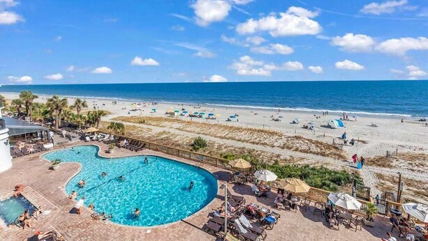 A pool area with a view of the beach and ocean. - Caribbean 2002 (Myrtle Beach)