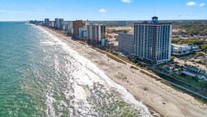 A coastal cityscape with a beachfront, high-rise buildings, and a clear sky. - Caribbean 2002 (Myrtle Beach)