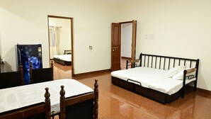 A room with a bed, a table with a chair, and a poster on the wall. - Serene  and very friendly Village settings.
Spacious and homely Atmosphere  (Kolve)