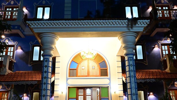 A two-story building with a central entrance, columns, and a balcony on the upper floor. - Serene  and very friendly Village settings.
Spacious and homely Atmosphere  (Kolve)