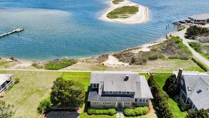 An aerial view of a coastal property with a large house, a dock, and a sandy beach. - Charming 6-bedroom oceanfront cottage in Falmouth (Falmouth)