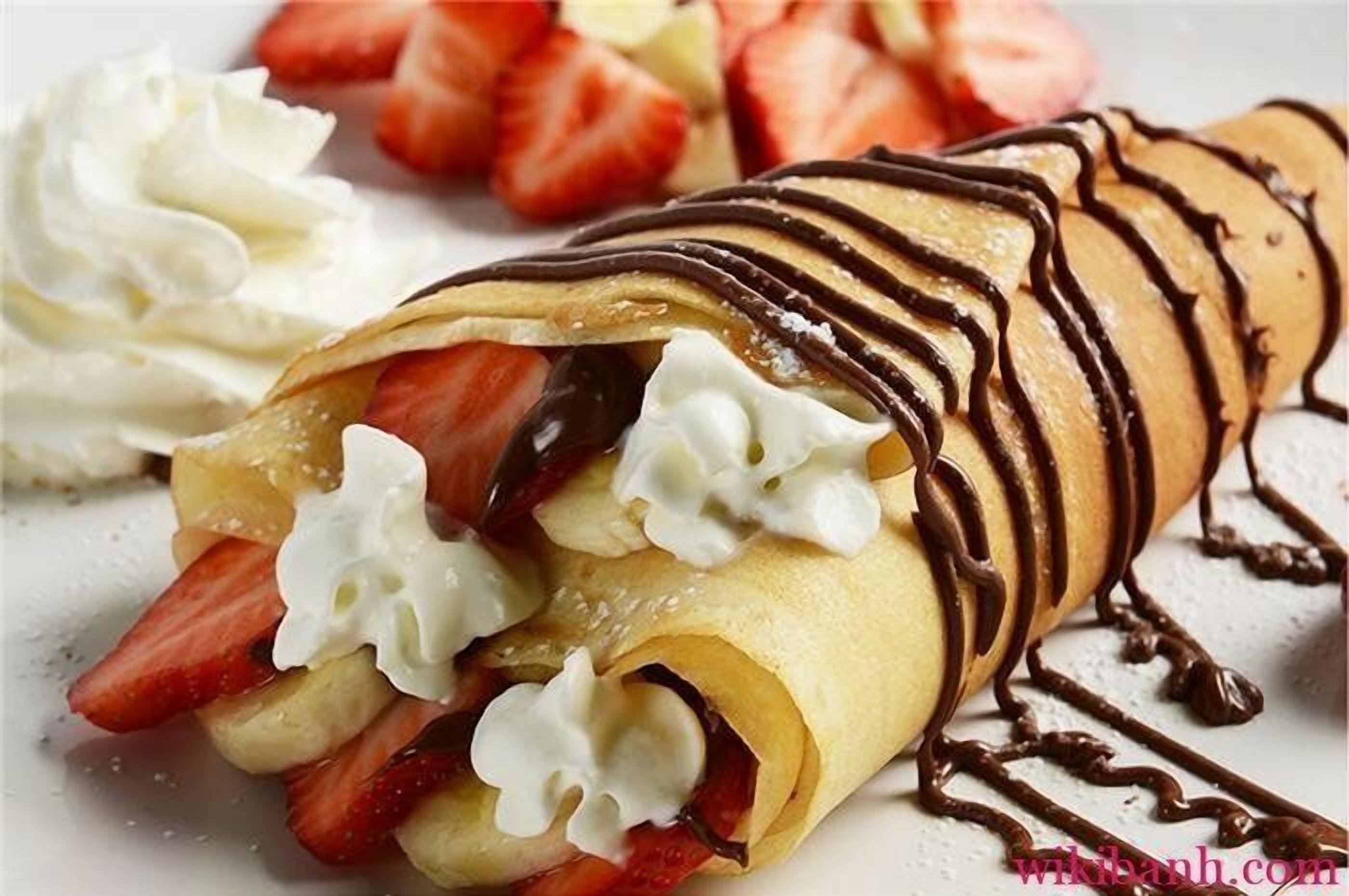 Un dessert aux fraises, à la crème fouettée et agrémenté d’un filet de chocolat.