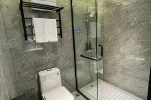 A modern bathroom with a glass-enclosed shower, a toilet, and a towel rack. - Zhengzhou University Institute of Technology Hotel (Zhengzhou)
