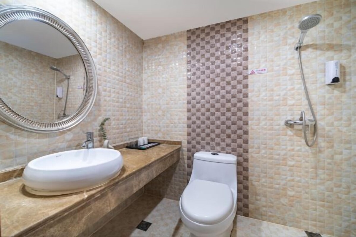 A bathroom with a sink, toilet, and shower.