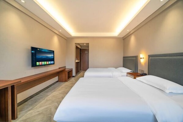 A hotel room with two beds, a TV mounted on the wall, and a bench. - Zhengzhou University Institute of Technology Hotel (Zhengzhou)