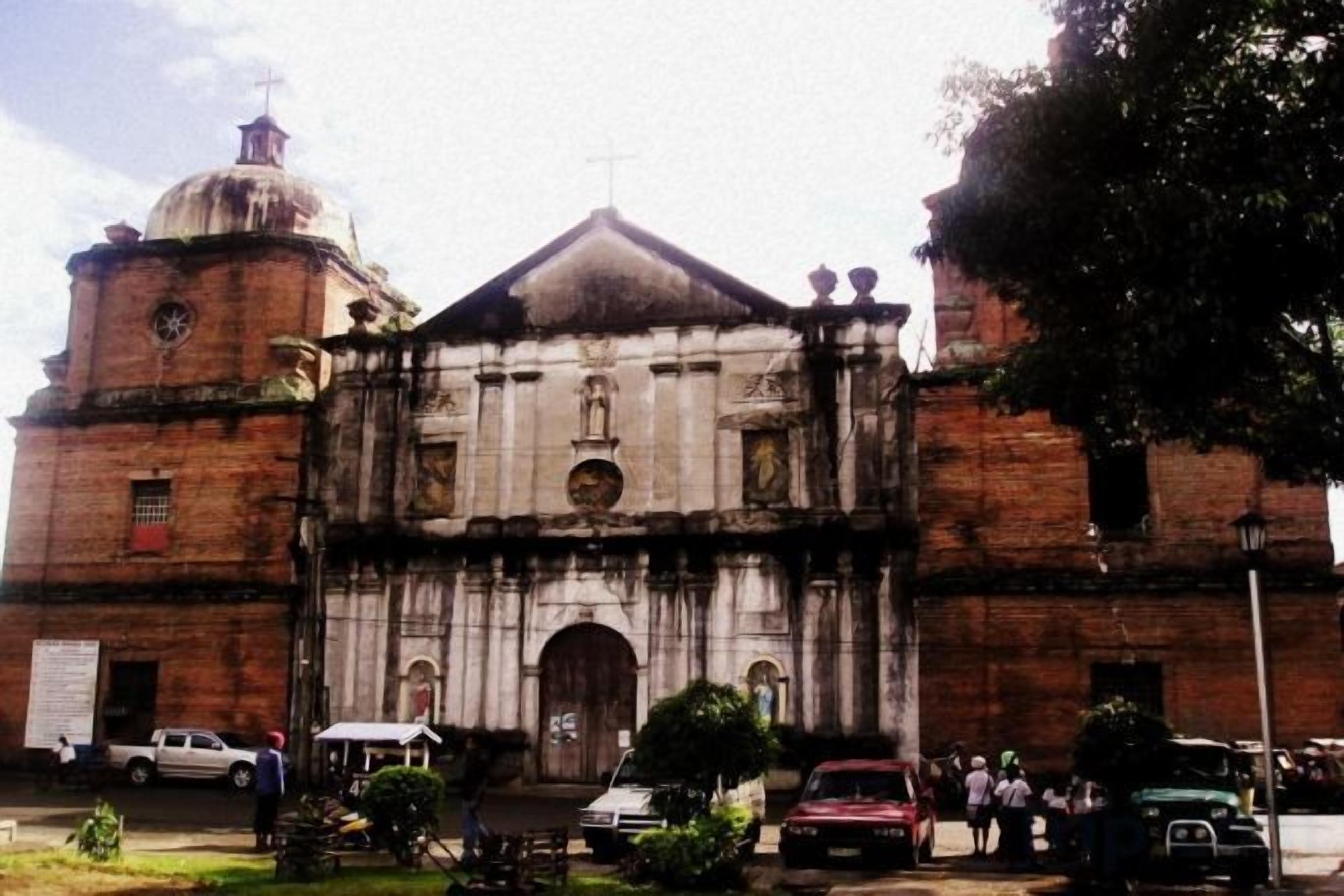 A large, historic building with a prominent dome and arched entrance.