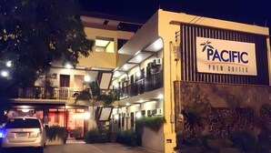 A multi-story building with a sign for 'Pacific Palm Suites'. - Pacific Palm Suites Davao powered by Cocotel (Davao)