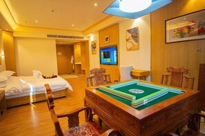 A hotel room with a bed, a pool table, and a television on the wall. - Dongfang Tanggula Hotel (High-speed Railway Station) (Dongfang)