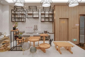 A modern kitchen with wooden furniture, built-in shelves, and a clean, minimalist design.