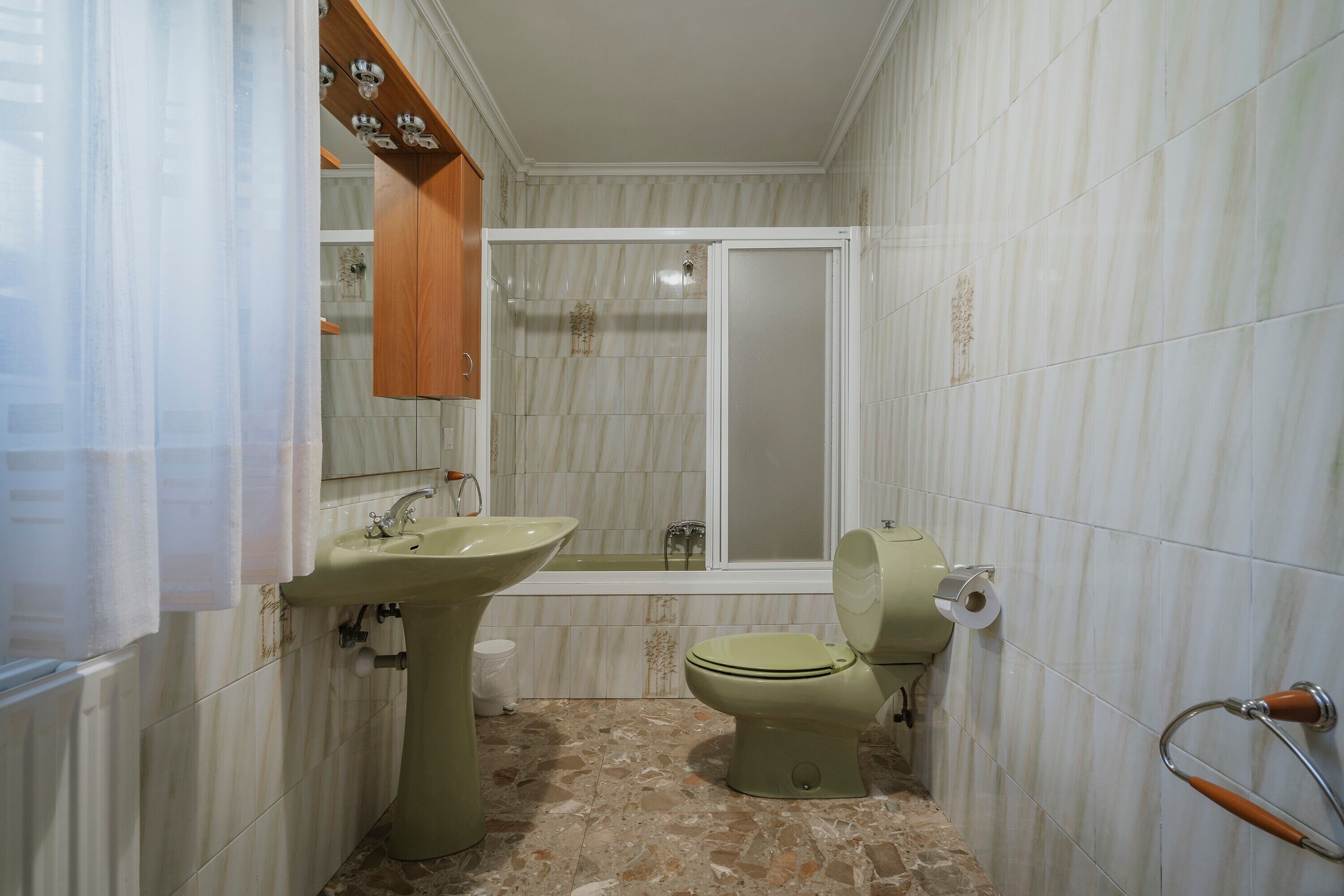 A bathroom with a sink, toilet, and bathtub.