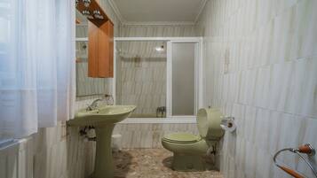 A bathroom with a sink, toilet, and bathtub.