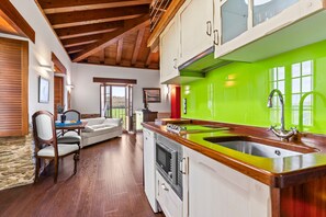 A kitchen with a green backsplash, wooden cabinets, a stainless steel sink, and a built-in oven. - Apartment 'Mr De Alborada Del Eo' with Mountain View, Wi-Fi and Air Conditioning (Villameitide)