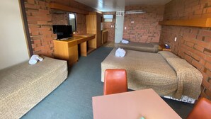 A compact room with two single beds, a small desk with a television, and a kitchenette area. - Hawker Hotel Motel (Hawker)