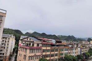 A multi-story building with a flat roof and a series of windows. - Debao Hongshanyuan Hotel (Debao)