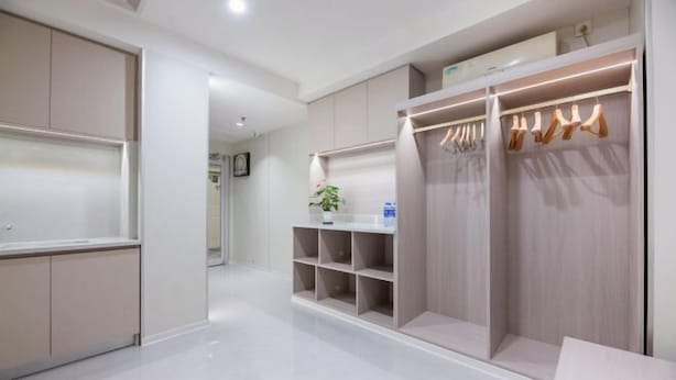 A modern, well-lit walk-in closet with organized shelves and hanging space. - Home Inn Plus Hotel (Shijiazhuang)