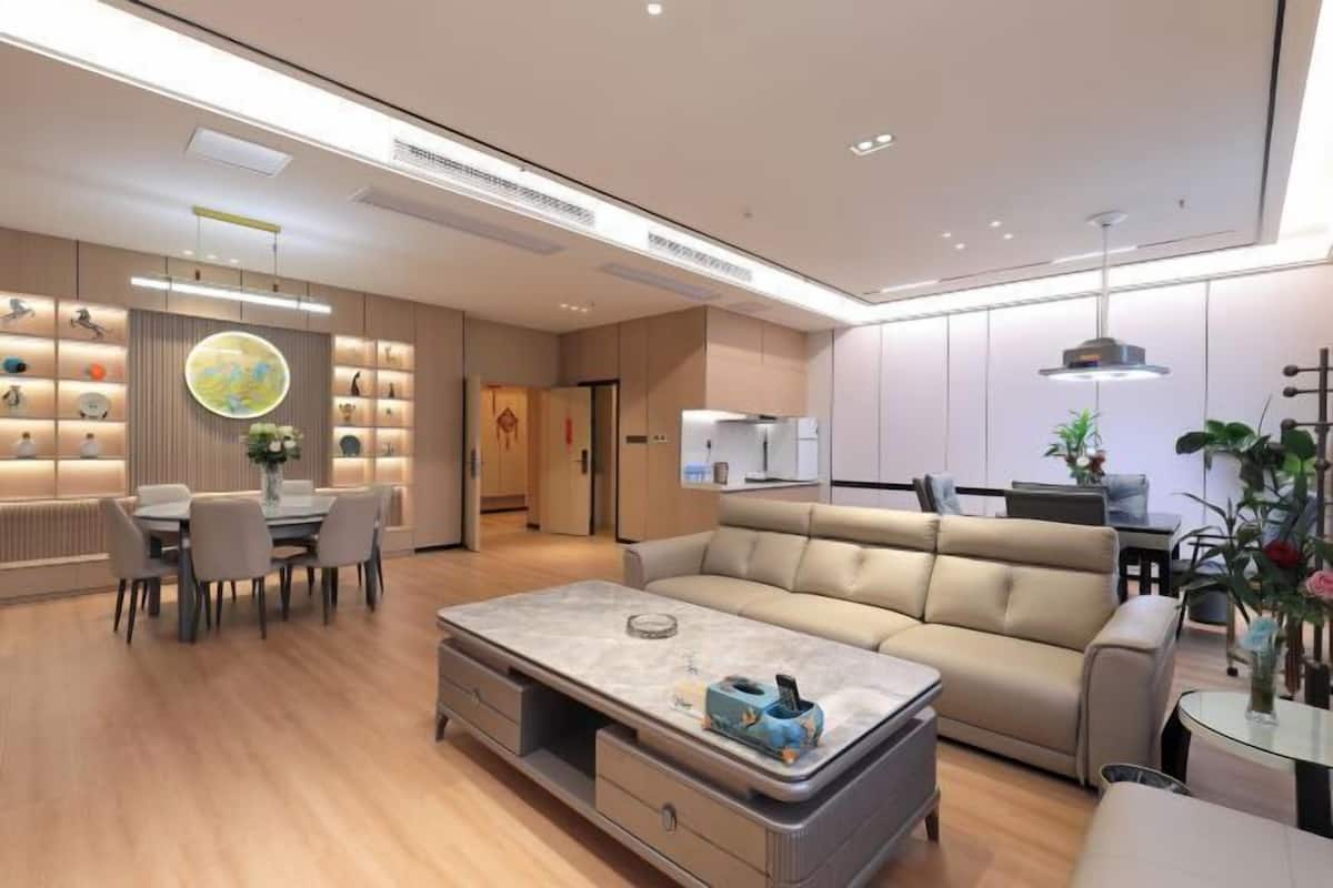 A modern living room with a sofa, dining table, and a coffee table.