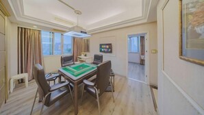 A spacious room with a large dining table, comfortable chairs, and a ceiling light fixture. - Dongsheng Hotel（Puning International Commodity City · High-speed Rail Station Branch） (Puning)