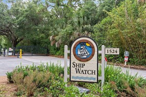 A sign with the text "Ship Watch" and the number "1524" in a natural setting with greenery. - Beachfront Condo | Pet Friendly | Pool | Kids Bikes | Beach Gear | Elevator | Covered Parking (St. Simons Island)