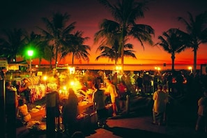 A bustling night market with vendors and customers. - Skytower Wonder Oceanview Balcony - Pool - Office (Darwin)