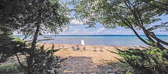 Torch Lake Getaway w/ Private Beach + Boat Dock!
