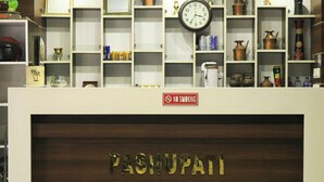 A reception desk with a sign reading "PASHUPATI HOTEL (P) LTD." and a "NO SMOKING" sign above it. - Pashupati Hotel  (Kathmandu)