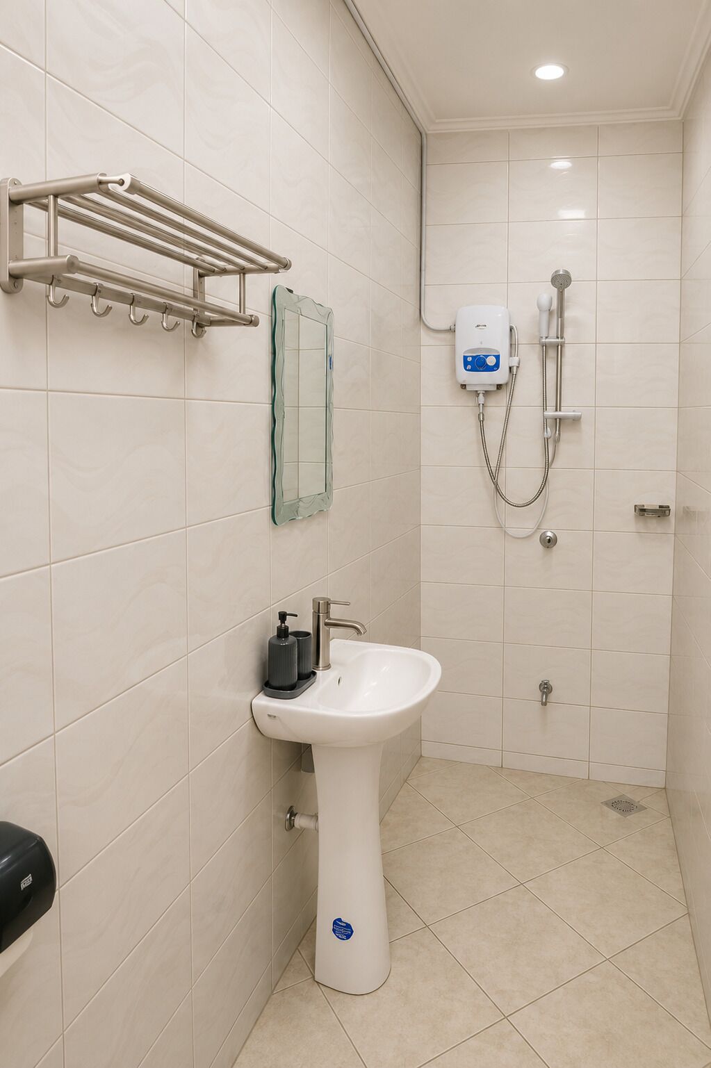 A bathroom with a sink, mirror, towel rack, and a shower with a handheld showerhead.