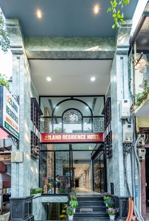 The entrance to 22Land Residence Hotel with a modern design, featuring a glass facade, a staircase leading to the entrance, and a signboard above the door. - 22land 71 Hang Bong Hotel (Hanoi)