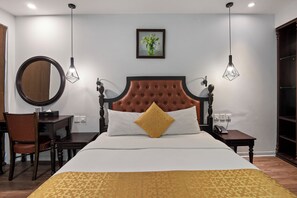 A neatly arranged hotel room with a large bed, a desk, a chair, and a small table with a telephone. - 22land 71 Hang Bong Hotel (Hanoi)